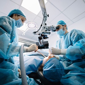 Dentists performing a dental implant surgery