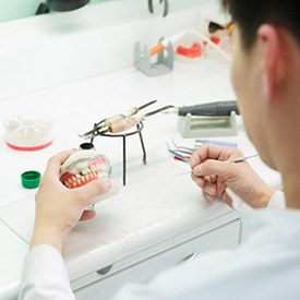 a lab technician working on creating new dentures